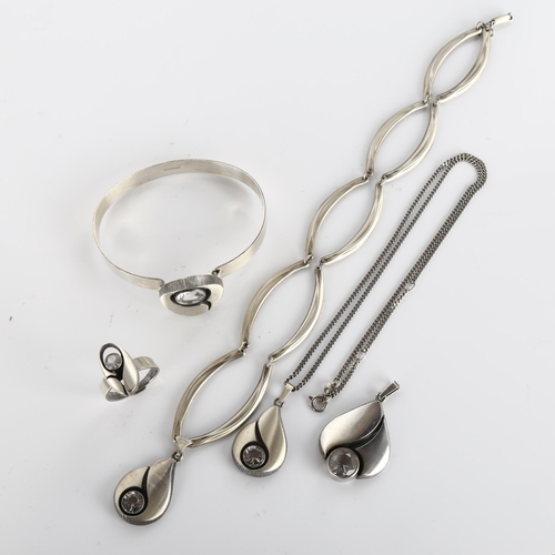 391 - A group of Finnish sterling silver and cubic zirconia jewellery, comprising 3 pendant necklaces, 1 t... 