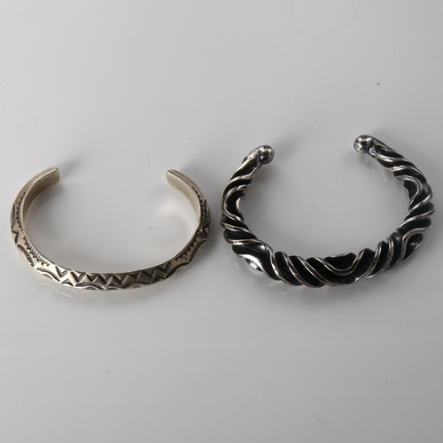 407 - A Mexican silver torque bangle, 33.4g, and a Continental unmarked white metal wavy bangle, 52.5g (2)