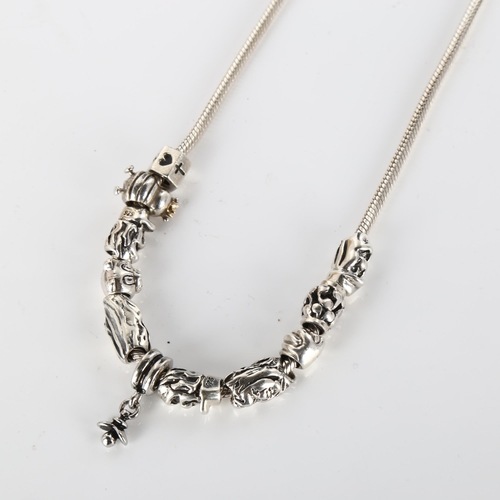 411 - PANDORA - a modern sterling silver snake link charm necklace, with 11 silver charms, length 41cm, 58... 