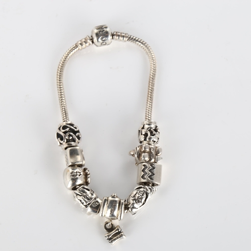 414 - PANDORA - a modern sterling silver snake link charm bracelet, with 9 silver charms, length 19cm, 42.... 