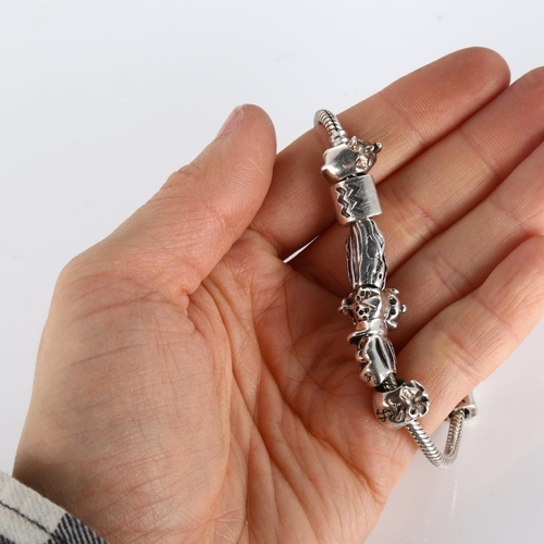 414 - PANDORA - a modern sterling silver snake link charm bracelet, with 9 silver charms, length 19cm, 42.... 