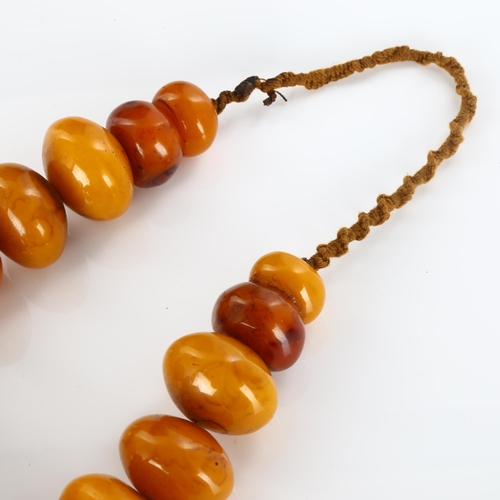 430 - A large Tribal prayer bead necklace, probably Bakelite, largest bead diameter 62.9mm, necklace lengt... 