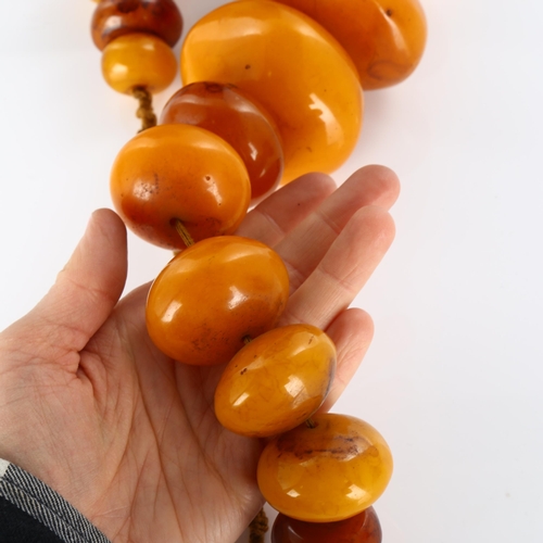 430 - A large Tribal prayer bead necklace, probably Bakelite, largest bead diameter 62.9mm, necklace lengt... 