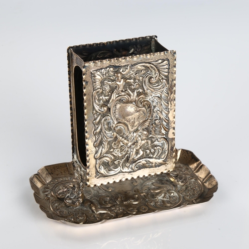 504 - A late Victorian silver upright matchbox holder, relief embossed foliate decoration with crimped tra... 