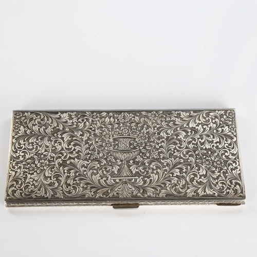 510A - A mid-20th Century Italian 800 silver cigarette case, allover engraved foliate decoration with centr... 