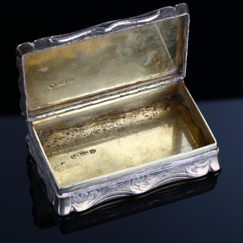 517 - A Victorian silver snuffbox, shaped rectangular form with allover foliate engraved decoration and gi... 