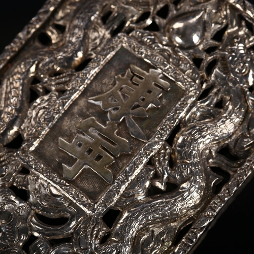 531 - A Chinese dragon belt buckle, unmarked white metal settings with central character marks and pierced... 