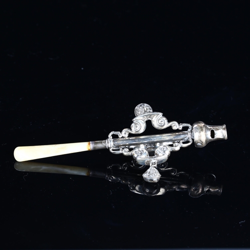 532 - A George V silver baby's rattle/whistle, with mother-of-pearl handle and openwork foliate design, by... 