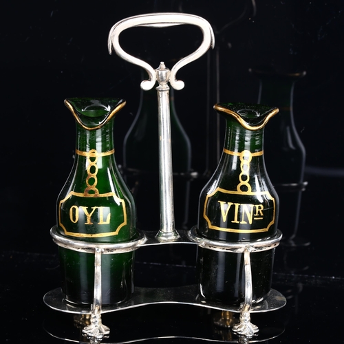 539 - A George V silver and green glass cruet set, with gilded glass bottles, named Oyl and Vinr, by Thoma... 