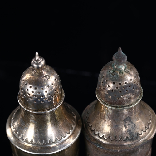 542 - A pair of Victorian silver urn pepperettes, half fluted decoration on pedestal bases, by Atkin Broth... 