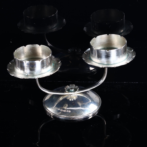 545 - An Arts and Crafts style Elizabeth II silver swivel candle holder, with flowerhead drip pans, maker'... 