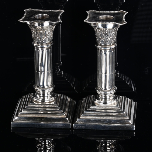 547 - A pair of Colonial silver Corinthian column candlesticks, maker's marks SB, height 15cm, loaded base... 