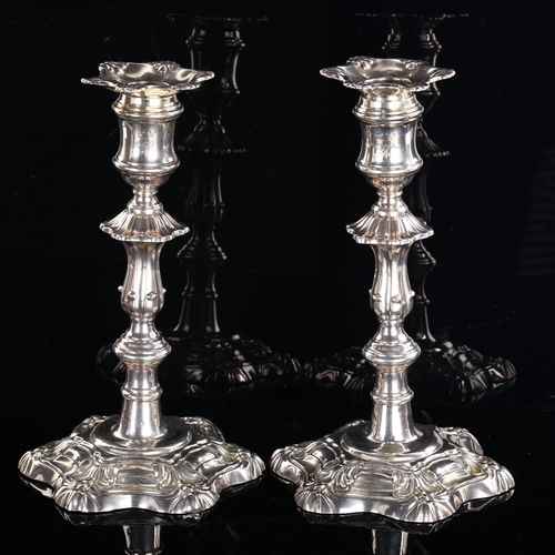 549 - A pair of George V silver table candlesticks, in Georgian style with removeable sconces and relief e... 