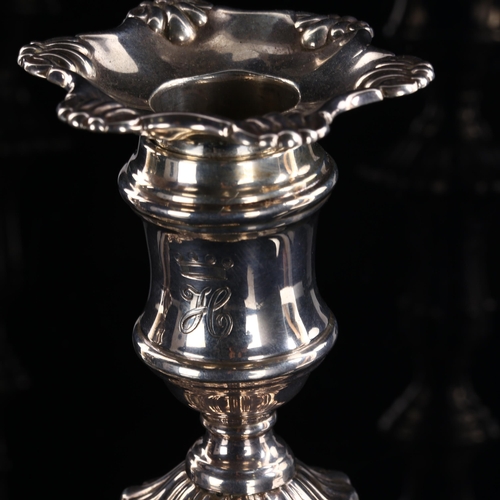 549 - A pair of George V silver table candlesticks, in Georgian style with removeable sconces and relief e... 