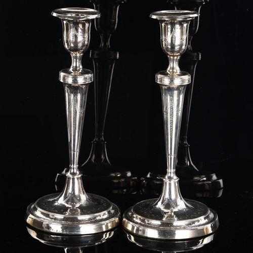 550 - A pair of Antique silver Regency table candlesticks, tapered stems with circular base and bright-cut... 