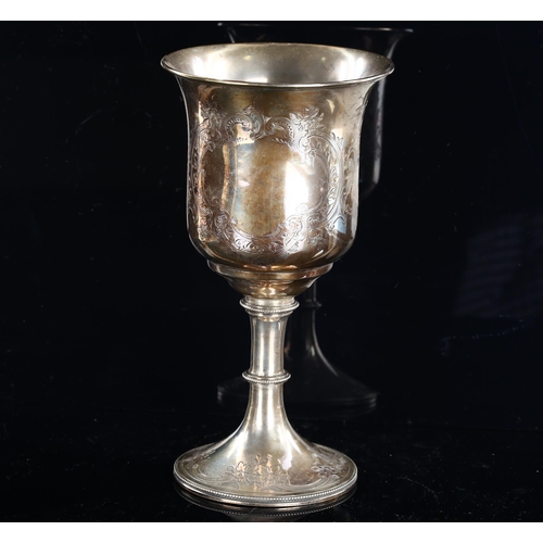 562 - A Victorian silver-gilt trophy goblet, engraved floral and foliate decoration with bead-edge, probab... 