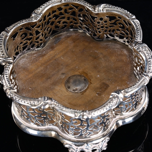 565 - A Victorian silver-mounted oak wine bottle coaster, lobed form with relief embossed beaded edge, pie... 