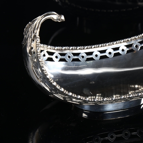 569 - GARRARD & CO LTD - a George V silver gondola sweetmeat dish, with pierced rim and engraved armorial ... 