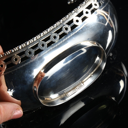 569 - GARRARD & CO LTD - a George V silver gondola sweetmeat dish, with pierced rim and engraved armorial ... 