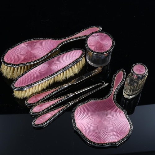 571 - An Art Deco George V silver and pink/black enamel 8-piece dressing table set, including hand mirror,... 