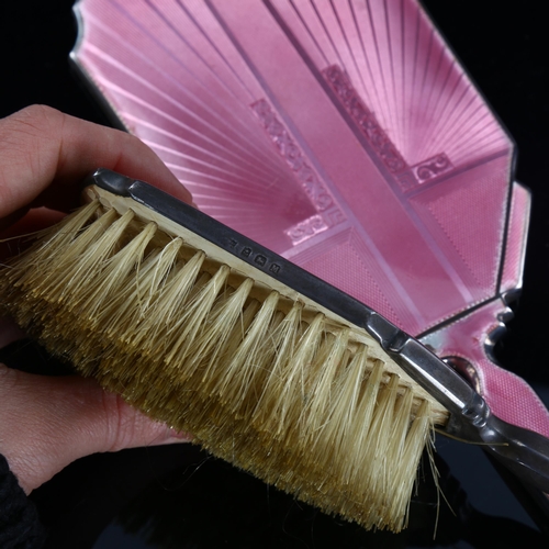 572 - An Art Deco silver and pink enamel 2-piece dressing table set, comprising hand mirror and hair brush... 