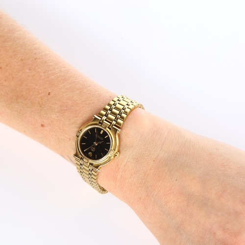 58 - GUCCI - a lady's gold plated 9200L quartz bracelet watch, black dial with gilt baton hour markers, s... 
