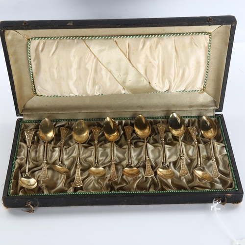 585 - A set of 12 Continental silver teaspoons, with relief flaming torch decoration, marked 750, length 1... 