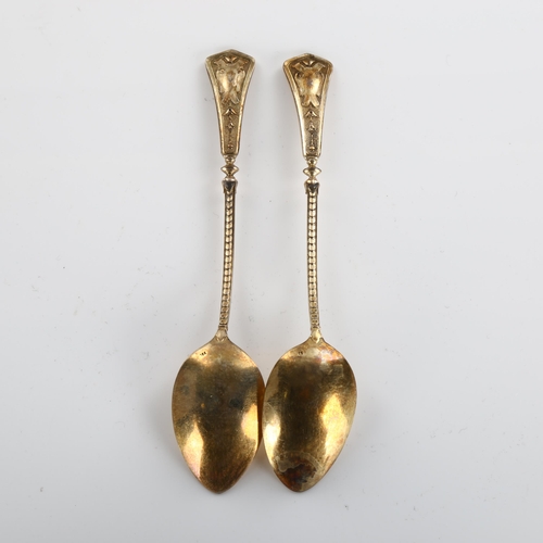 585 - A set of 12 Continental silver teaspoons, with relief flaming torch decoration, marked 750, length 1... 