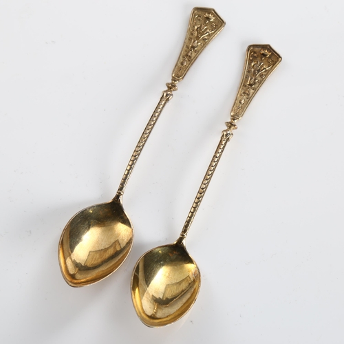 585 - A set of 12 Continental silver teaspoons, with relief flaming torch decoration, marked 750, length 1... 