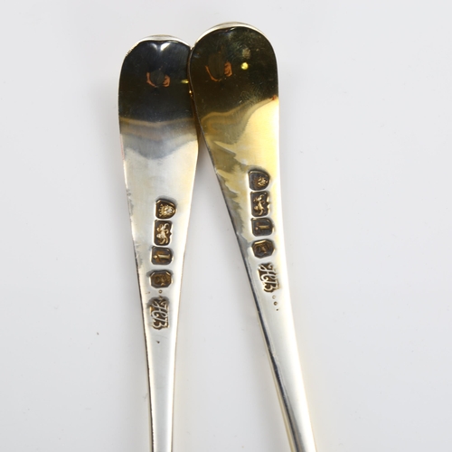 587 - A pair of George III silver Old English pattern berry spoons, bright-cut engraved and relief embosse... 