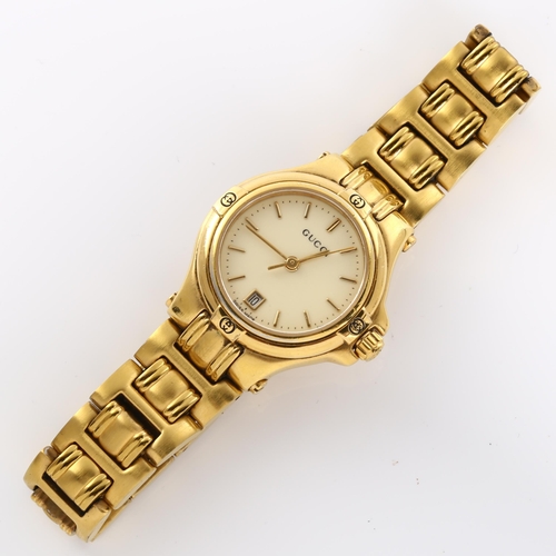 59 - GUCCI - a lady's gold plated 9240L quartz bracelet watch, cream dial with gilded baton hour markers,... 