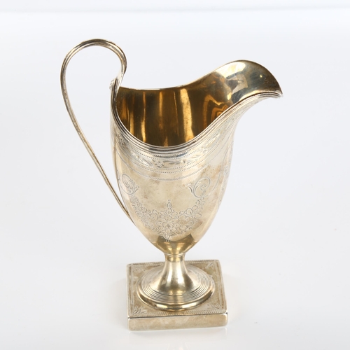 609 - A George III silver helmet pedestal cream jug, bright-cut engraved decoration by Peter and Ann Batem... 