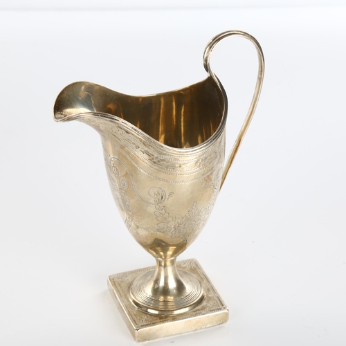 609 - A George III silver helmet pedestal cream jug, bright-cut engraved decoration by Peter and Ann Batem... 