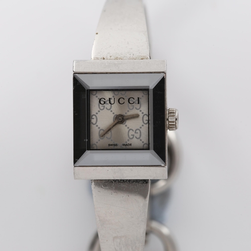 61 - GUCCI - a lady's stainless steel quartz bracelet watch, ref. 128.5, square GG monogram dial with mir... 