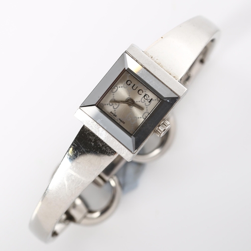 61 - GUCCI - a lady's stainless steel quartz bracelet watch, ref. 128.5, square GG monogram dial with mir... 