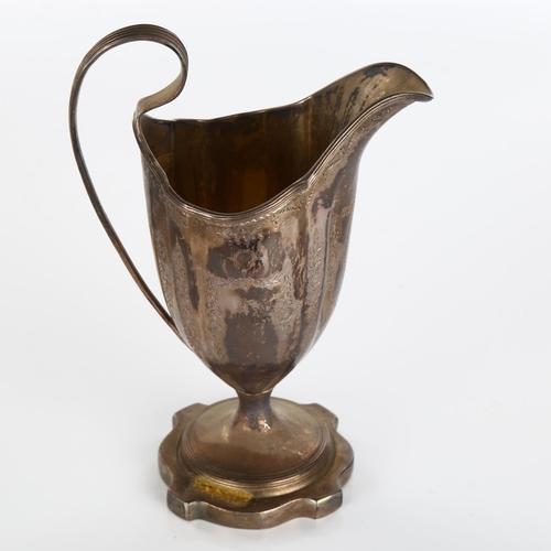 610 - A George III silver helmet pedestal cream jug, bright-cut engrave decoration with reeded edge and gi... 