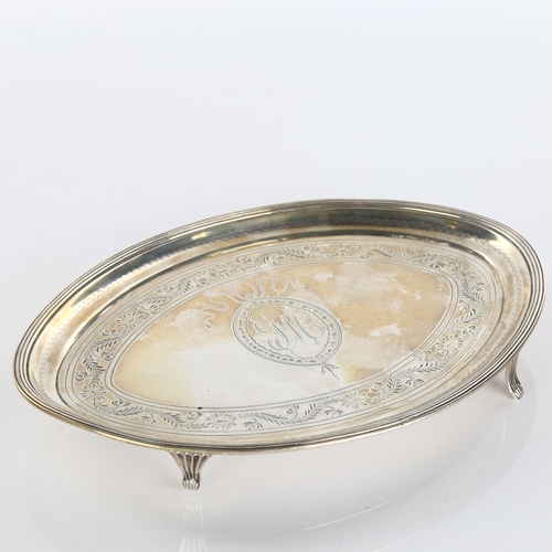 612 - A George III silver teapot stand, oval form with bright-cut engraved decoration, by Peter and Ann Ba... 