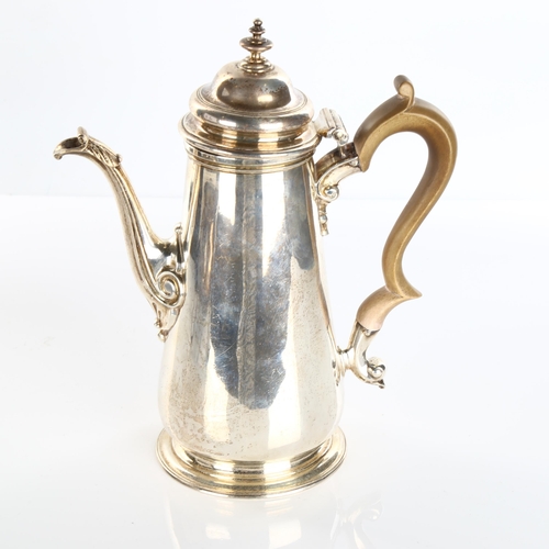 614 - A George II silver coffee pot, tapered cylindrical form with turned wood handle and scrolled acanthu... 