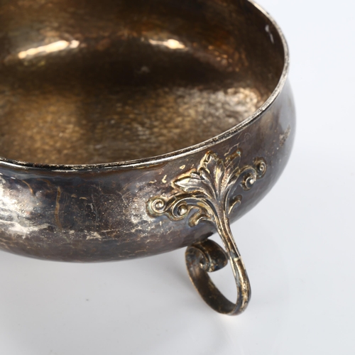 615 - An Art Nouveau George V silver fruit bowl, allover hand planished decoration, with scrolled foliate ... 