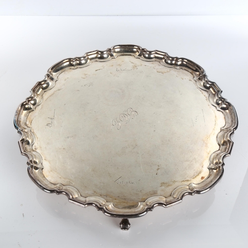 620 - A large George VI circular silver salver, scalloped rim with scrolled feet, by Atkin Brothers, hallm... 