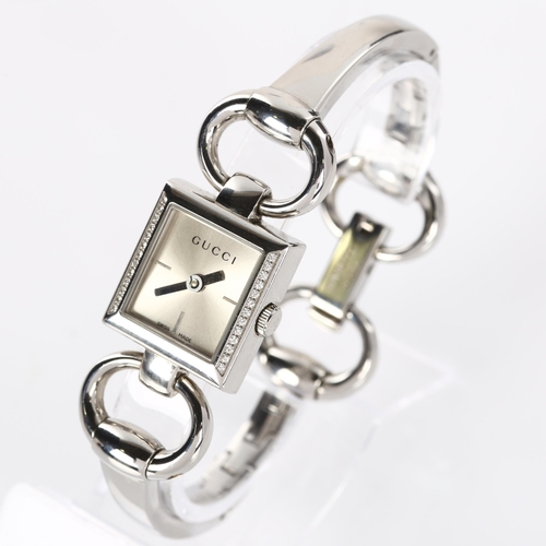 66 - GUCCI - a lady's stainless steel Tornabuoni quartz bracelet watch, ref. 120, silvered dial with diam... 