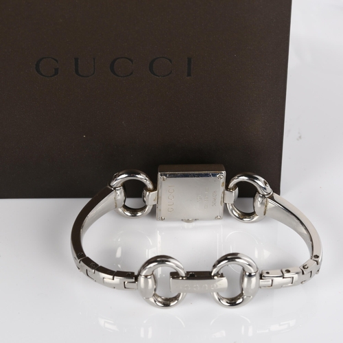 66 - GUCCI - a lady's stainless steel Tornabuoni quartz bracelet watch, ref. 120, silvered dial with diam... 