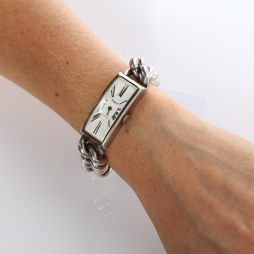 32 - PHIGIED - a lady's heavy sterling silver mechanical bracelet watch, curved rectangular white dial wi... 