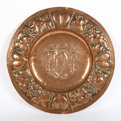 313 - A Gothic Art Nouveau copper church alms plate, relief embossed heart and grapevine surround, diamete... 