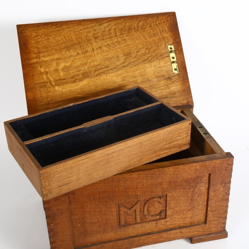 174 - An early 20th century Gothic style oak jewellery box, with fitted inner tray, with monogrammed panel... 