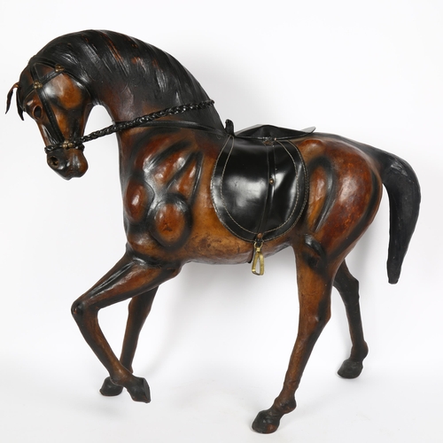 18 - A large Antique leather-covered horse figure, height 66cm, length 66cm
