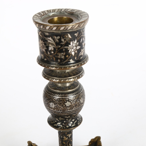 181 - A silver and brass inlaid candlestick on a pierced brass and enamel inlaid plinth base, height 19cm