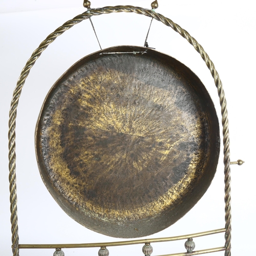 192 - An early 20th century brass gong on stand, height 74cm