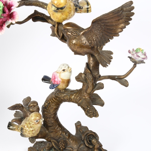 2 - A pair of Art Nouveau French bronze and porcelain 'birds on branch' sculptures, with hand painted po... 