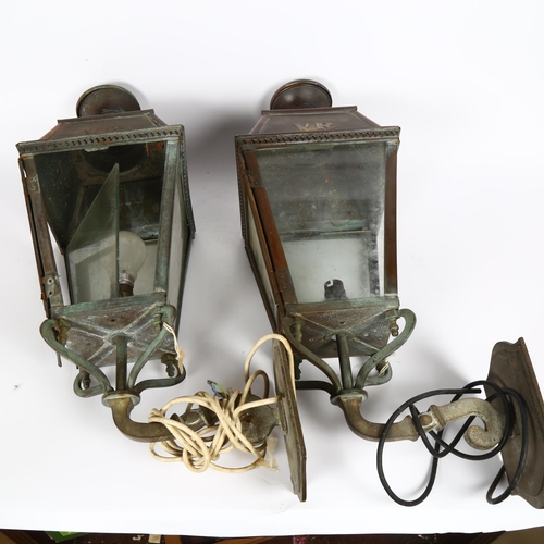 20 - A pair of Victorian copper-framed wall lanterns, with embossed VR cypher, overall height 64cm, lante... 